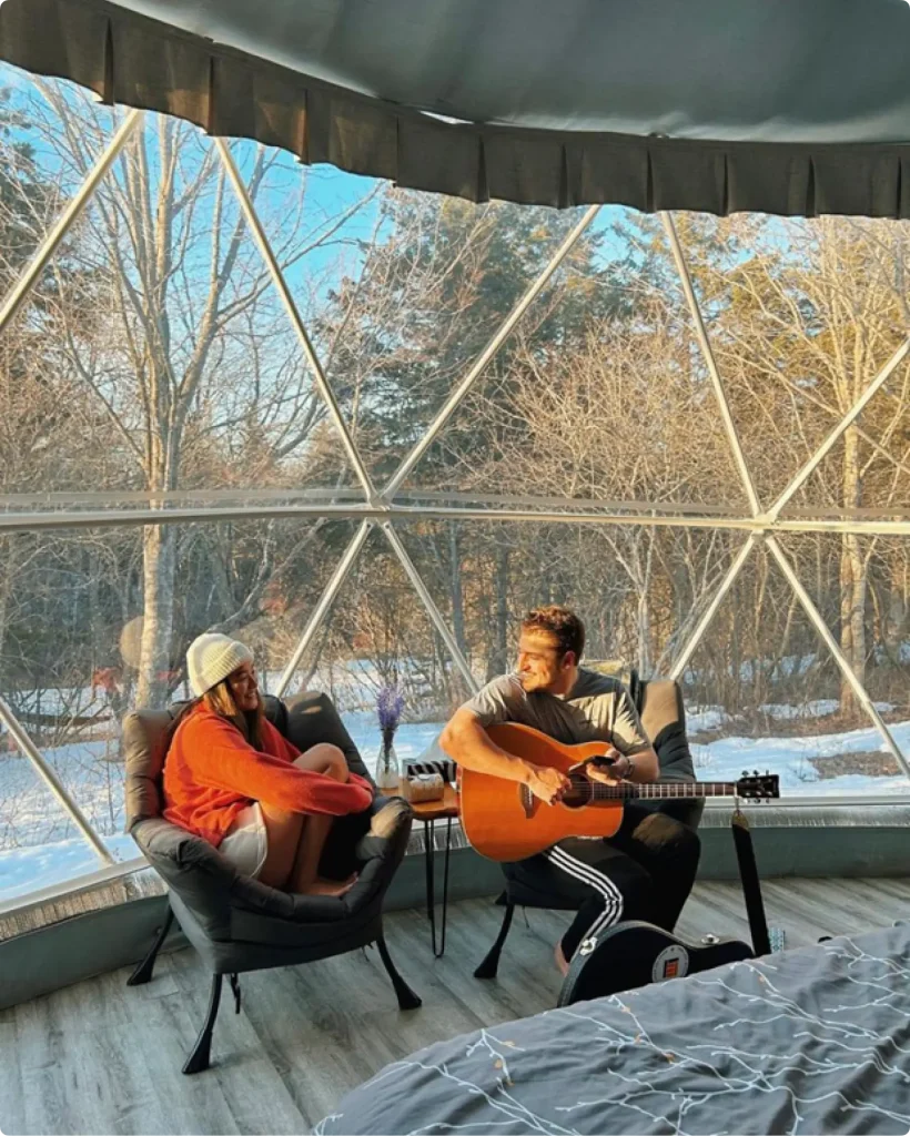 A couple sings and chats in the geodesic dome home event tent heaters