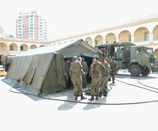 People Stand In The Out Of Army Surplus Tents(1)